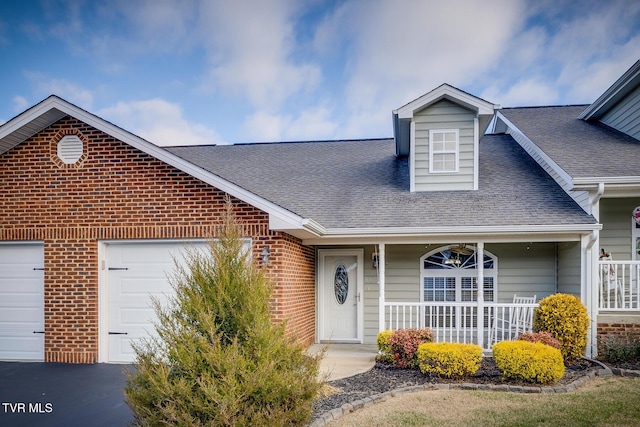 view of front of house with a porch and a garage