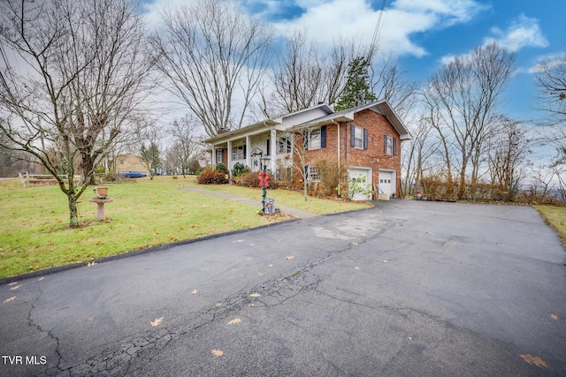 view of front of property featuring a garage and a front lawn