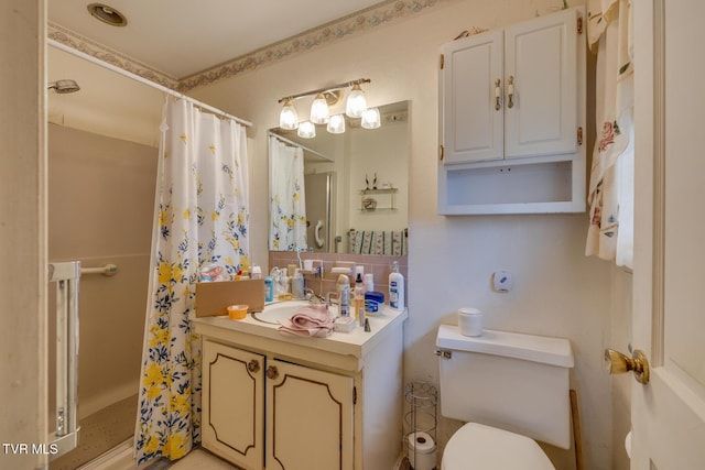 bathroom with vanity, toilet, and curtained shower