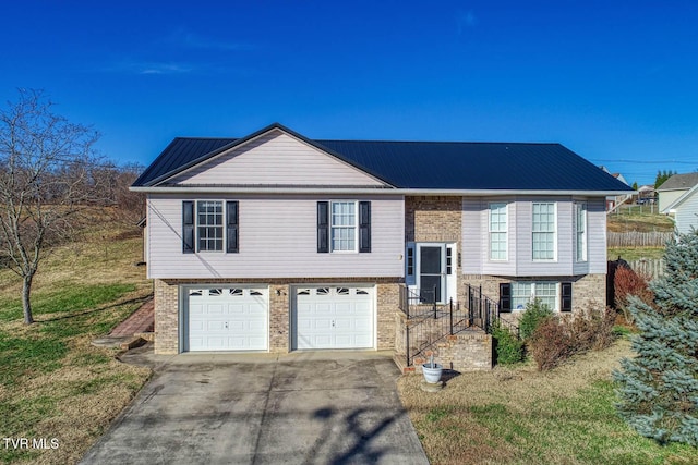 bi-level home featuring a garage and a front lawn