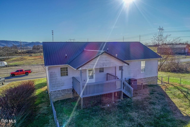 back of house featuring a porch and a lawn