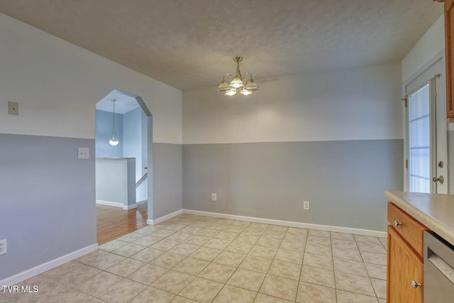 unfurnished room with a chandelier, a textured ceiling, and lofted ceiling