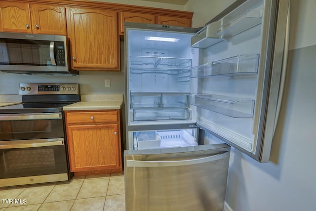 kitchen featuring light tile patterned floors and appliances with stainless steel finishes