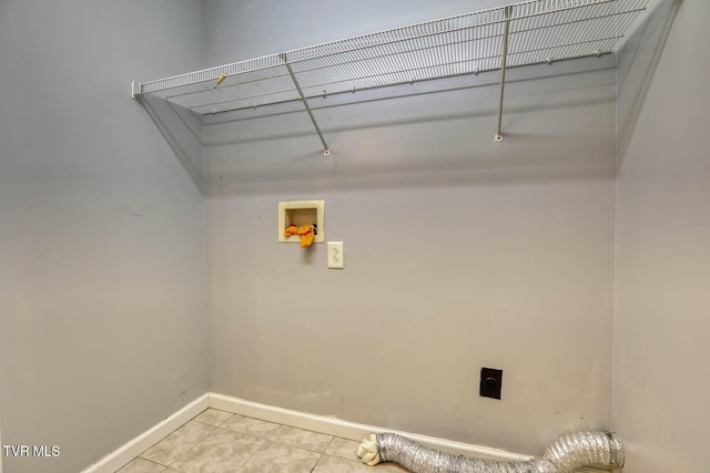 clothes washing area with hookup for an electric dryer, light tile patterned floors, and hookup for a washing machine