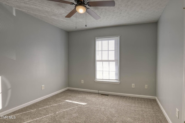 unfurnished room featuring ceiling fan, carpet floors, and a textured ceiling