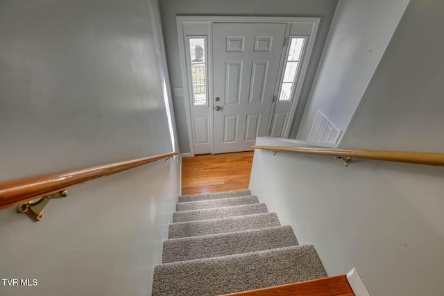 stairway with hardwood / wood-style floors