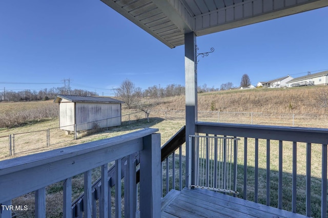 wooden terrace with a lawn and a shed