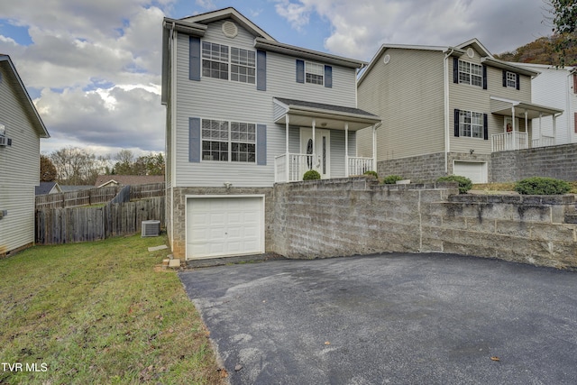 view of property with central AC, a front lawn, and a garage