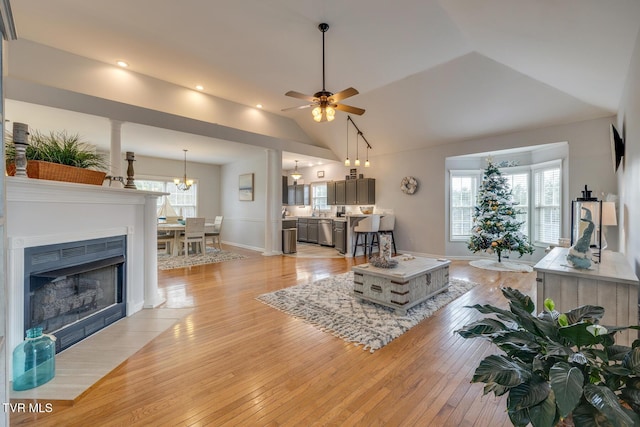 living room with light hardwood / wood-style flooring, ceiling fan, and lofted ceiling