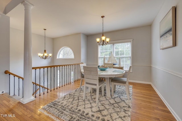 dining space with a wealth of natural light, a chandelier, and light hardwood / wood-style floors