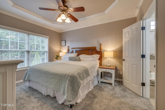 carpeted bedroom featuring a raised ceiling, ceiling fan, and ornamental molding