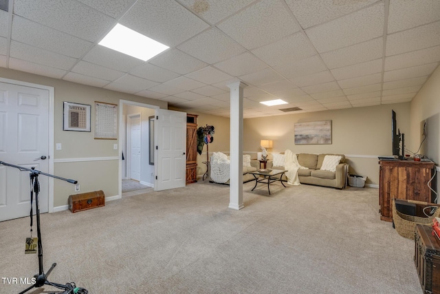 basement featuring a drop ceiling and light carpet