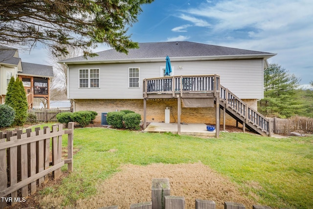 back of house with a patio, a lawn, and a wooden deck