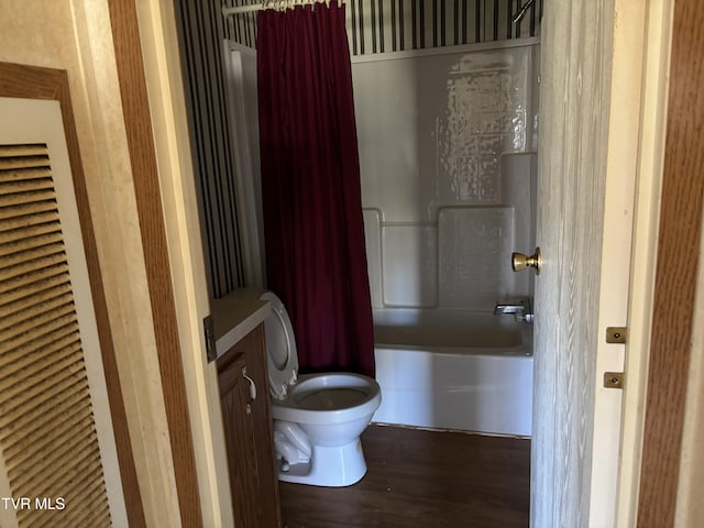 full bathroom with hardwood / wood-style floors, vanity, toilet, and shower / bathtub combination with curtain