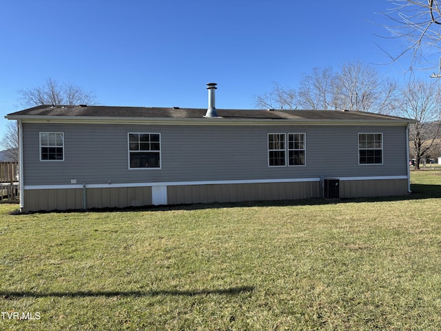 back of house featuring a yard and central AC