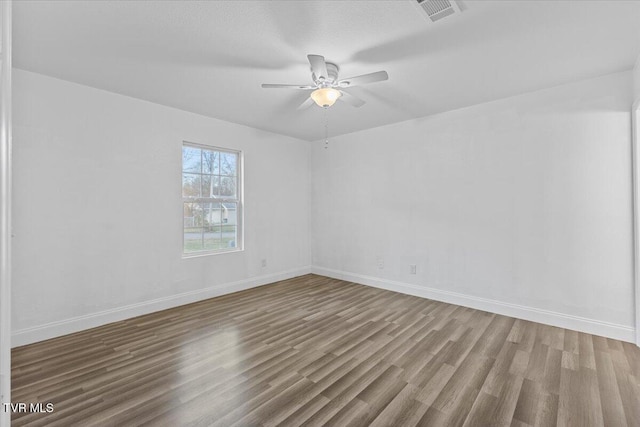 empty room featuring ceiling fan and hardwood / wood-style floors