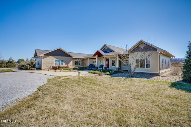 view of front of property featuring covered porch and a front lawn