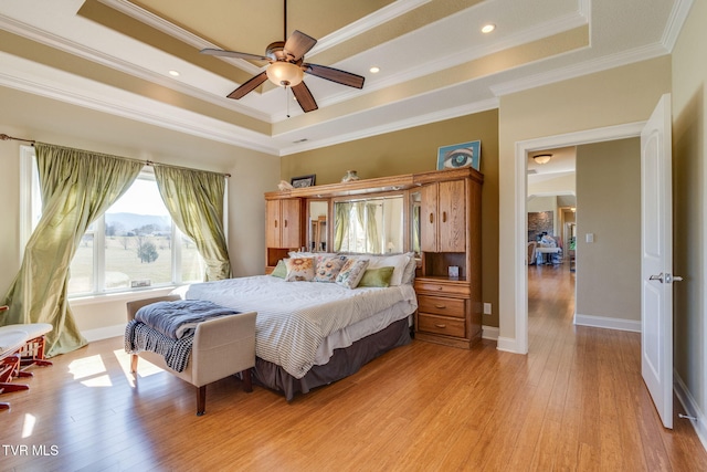 bedroom featuring light wood-style flooring, recessed lighting, baseboards, a raised ceiling, and crown molding