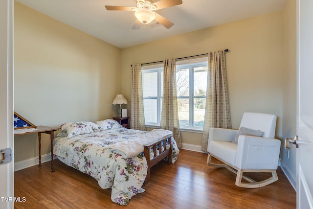 bedroom featuring a ceiling fan, baseboards, and wood finished floors