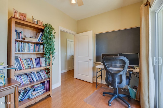 home office featuring ceiling fan, baseboards, and wood finished floors