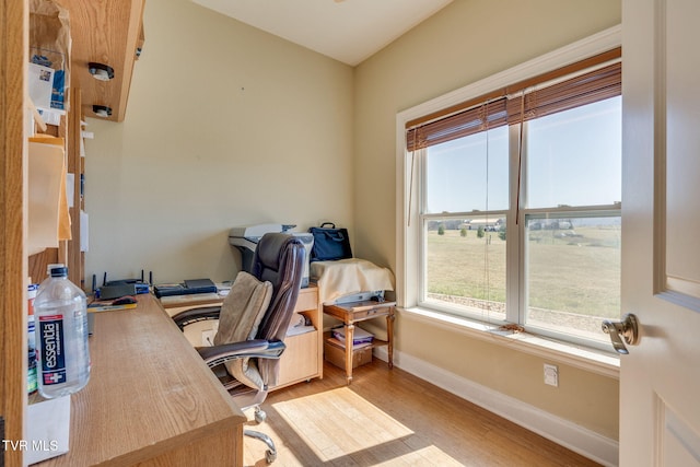 office space featuring baseboards and wood finished floors