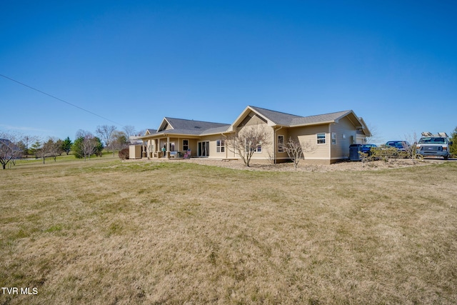 back of house featuring a patio and a yard