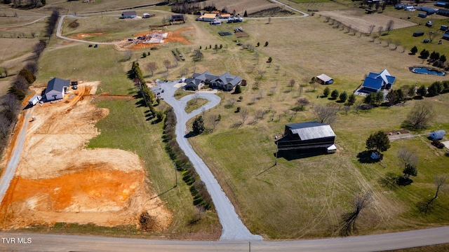 birds eye view of property with a rural view