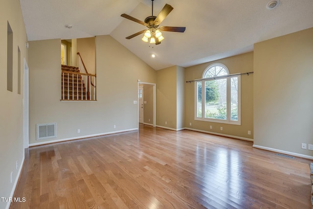 unfurnished living room with ceiling fan, high vaulted ceiling, and light hardwood / wood-style flooring