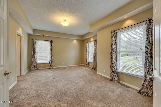 carpeted spare room with a textured ceiling