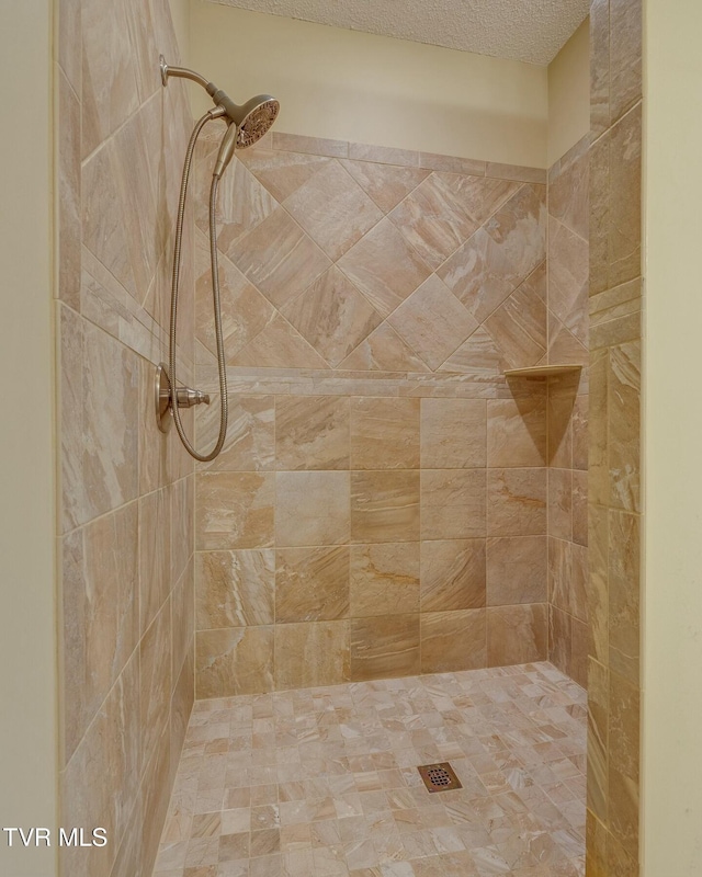 bathroom with a tile shower