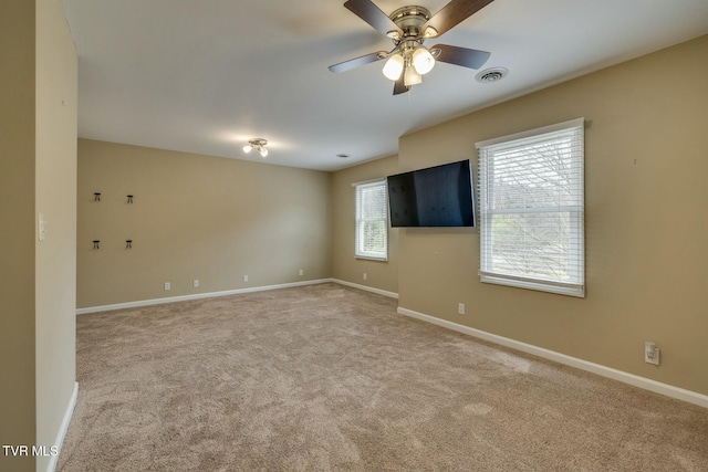 empty room featuring carpet flooring and ceiling fan