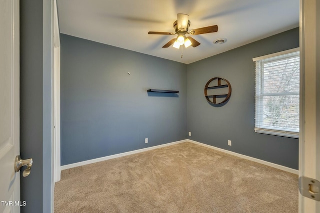 spare room with light carpet and ceiling fan