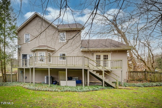 back of house featuring cooling unit, a yard, and a wooden deck