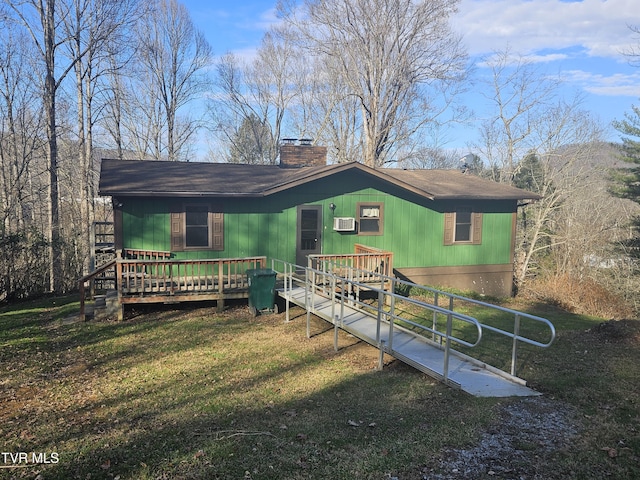 back of property featuring a yard and a deck