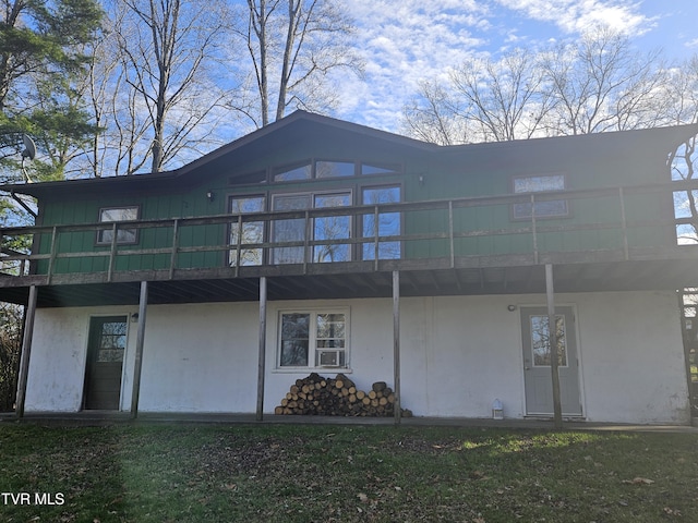 rear view of house with a wooden deck