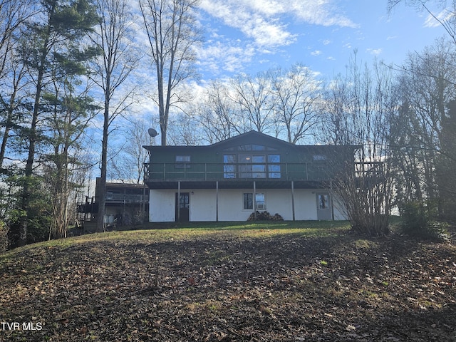 back of house with a deck