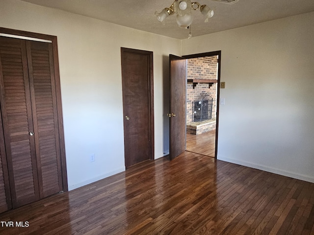 unfurnished bedroom featuring dark wood-type flooring