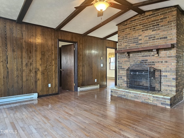 unfurnished living room featuring a brick fireplace, baseboard heating, wooden walls, lofted ceiling with beams, and hardwood / wood-style floors