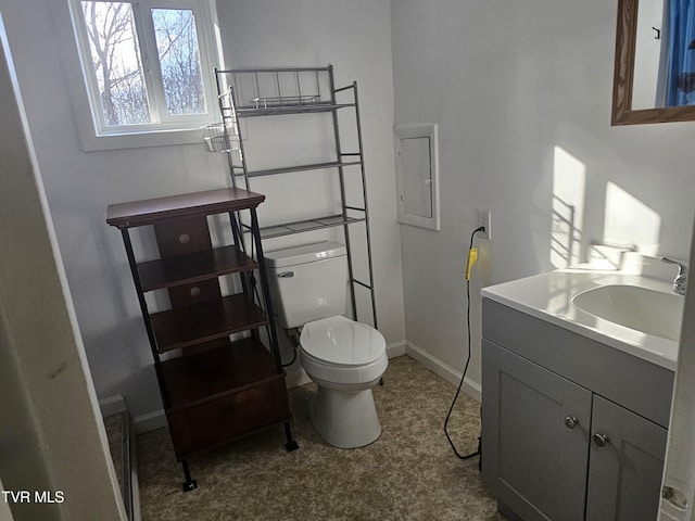 bathroom with vanity, toilet, and electric panel