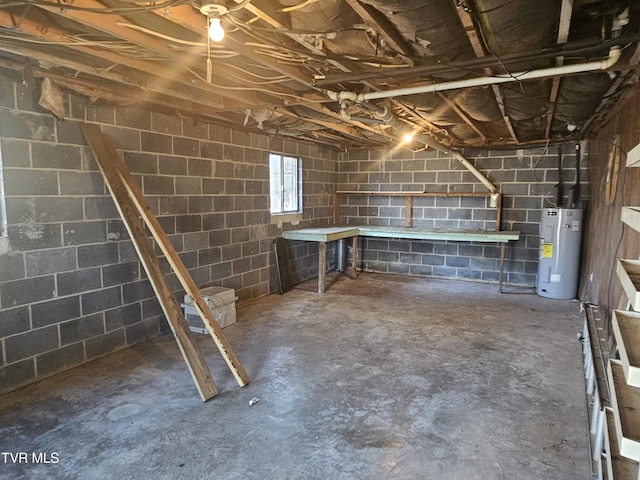 basement featuring a workshop area and water heater