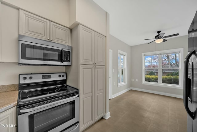 kitchen with ceiling fan and appliances with stainless steel finishes