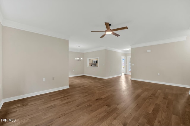 unfurnished living room with ceiling fan with notable chandelier, ornamental molding, and dark wood-type flooring