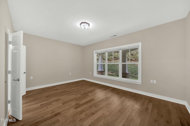 empty room with wood-type flooring