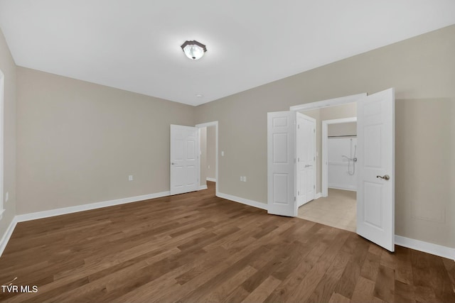 unfurnished bedroom with hardwood / wood-style floors