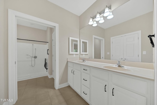 bathroom featuring vanity, tile patterned floors, and walk in shower