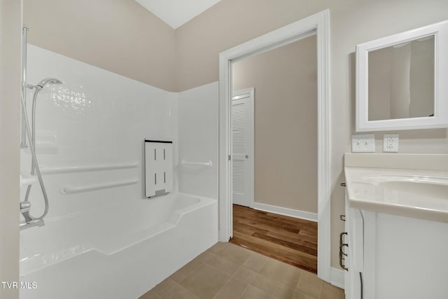 bathroom featuring tile patterned flooring, vanity, and tub / shower combination