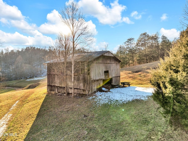 view of outdoor structure featuring a lawn