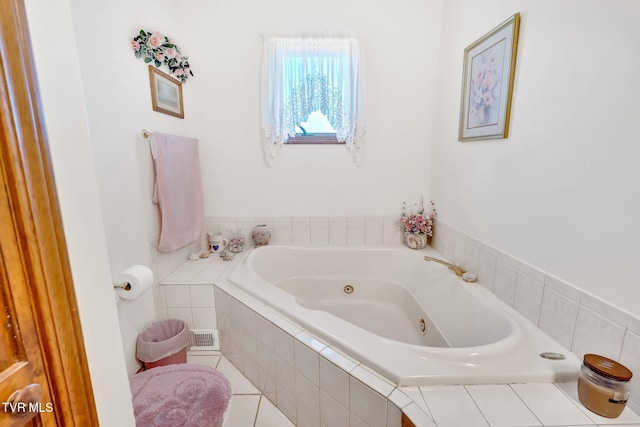 bathroom with tile patterned floors and tiled tub