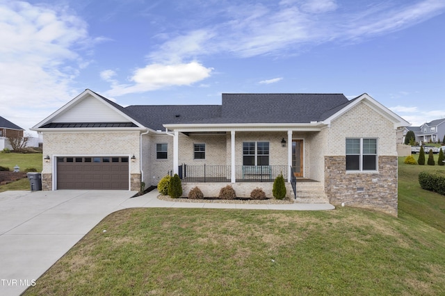 view of front facade with a garage, covered porch, and a front yard