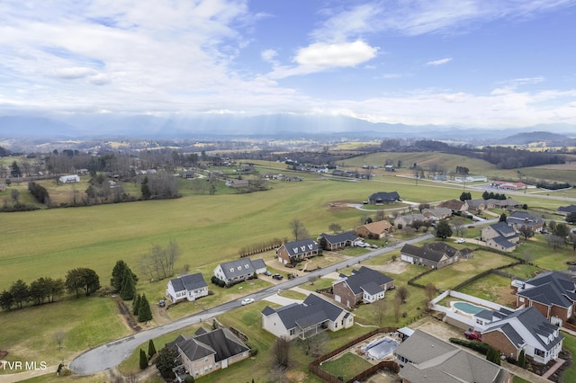 birds eye view of property featuring a mountain view